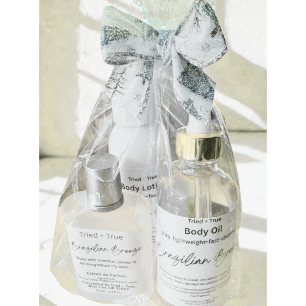 Set of Tried + True body lotion and body oil bottles wrapped together with a decorative bow.